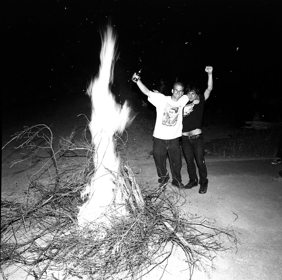 Frank Gerwer and John Cardiel make a fire to party.